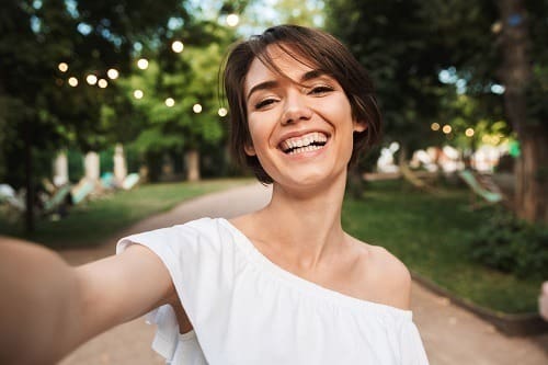 smiling-young-girl-taking-a-selfie